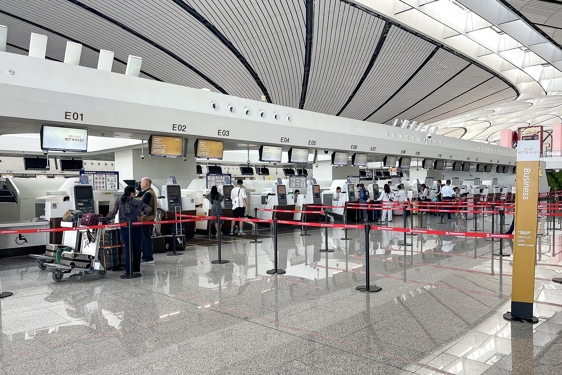 Passengers checking in at Etihad Airways counters in Beijing Daxing International Airport's Area E.