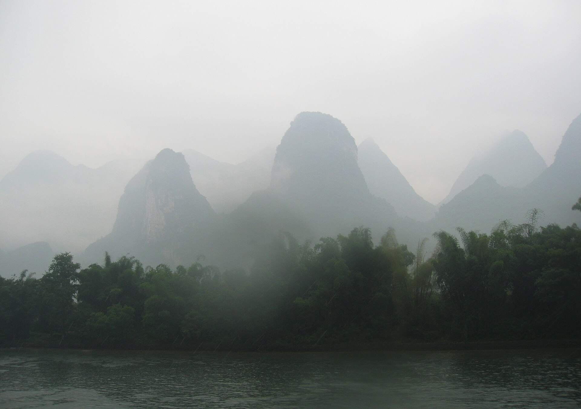 Mist over karst hills and bamboo along the Li River near Guilin in May 2008.