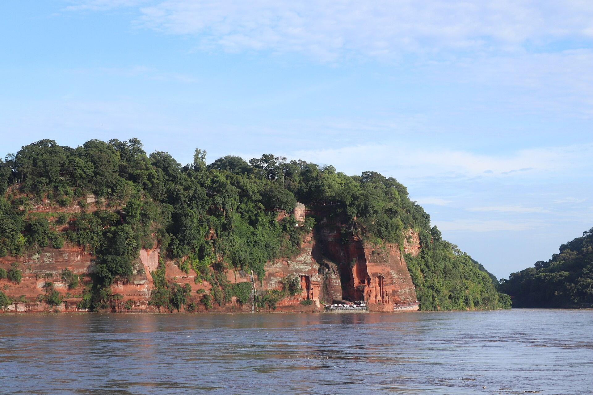 The full Leshan Giant Buddha seen at a distance across the Min River in August 2023.