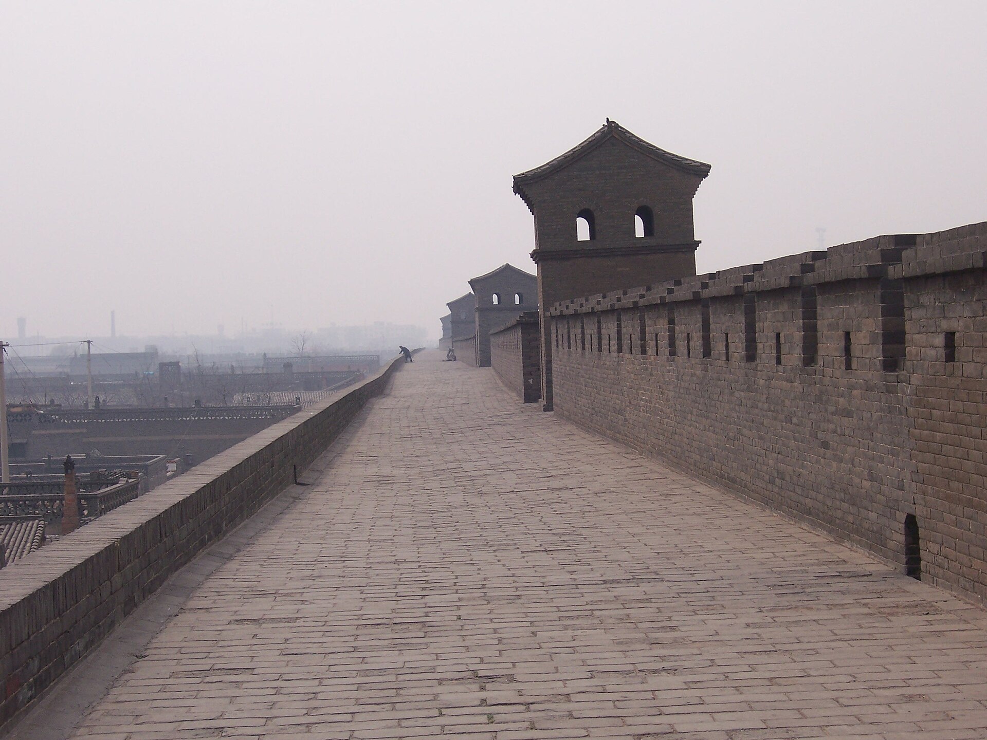 A long brick walkway and watchtowers extend along Pingyao's old city wall in April 2006.