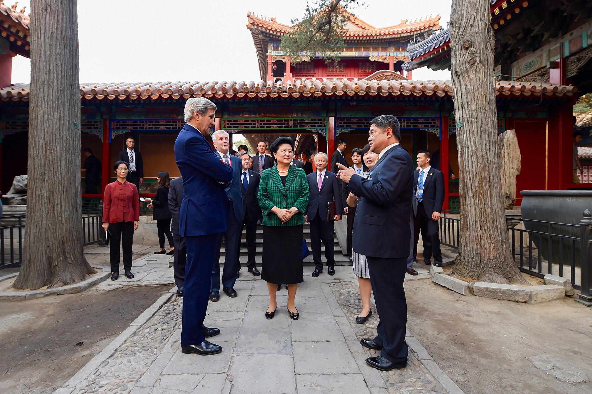 A source-identified tour guide addressing an official delegation in Emperor Qianlong's Garden at Beijing's Forbidden City in 2016.