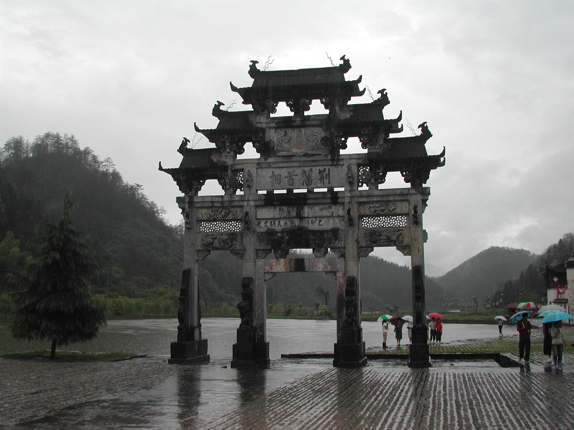 The Hu Wenguang Cishi stone archway stands in rain at Xidi village in Anhui.