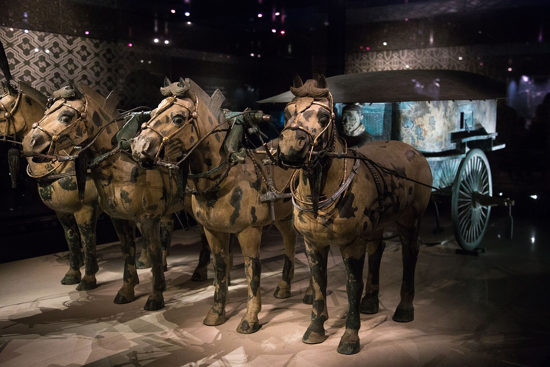 Qin bronze chariot No. 2 with four bronze horses behind display glass in April 2015.
