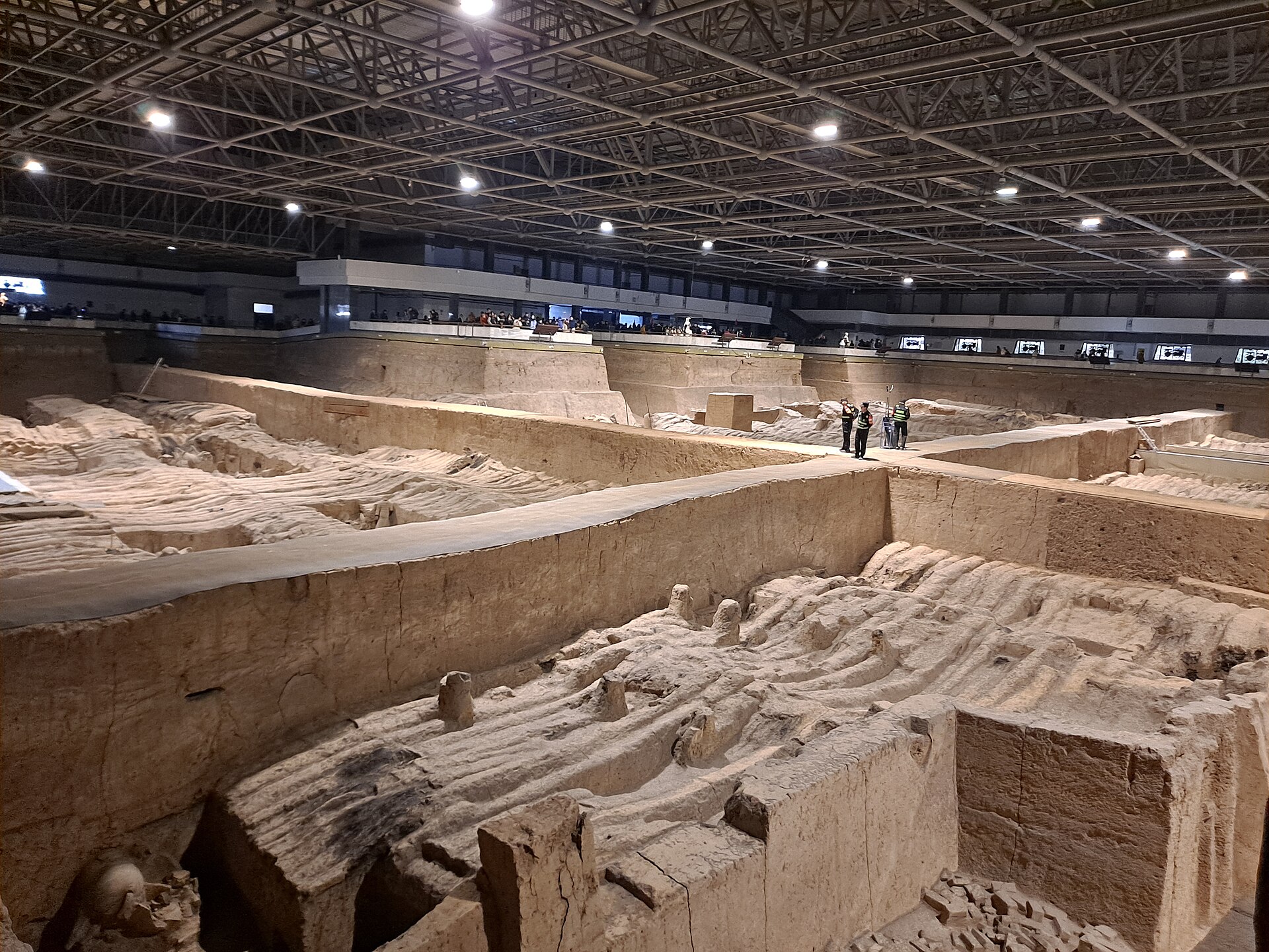 Excavation trenches and exposed terracotta figures in Pit 2 in November 2025.